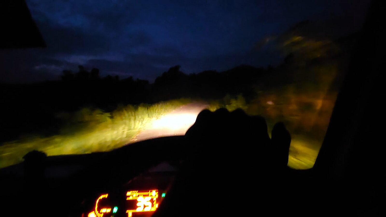 Headlights and dashboard glow on the dark drive back from the mountain